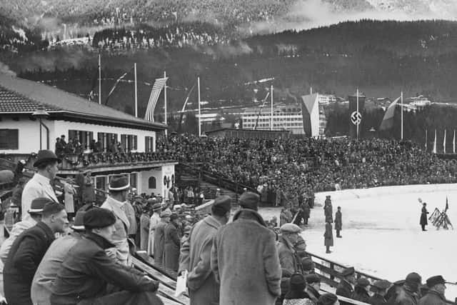 View of the grandstands of the Grosse Olympiaschanze (Great Olympic Hill) with the flags of all participating nations of the 1936 Winter Olympics in Garmisch-Partenkirchen, Germany, 2nd February 1936. With the flag of Czechoslovakia flying beside the Nazi flag. (Photo by European/FPG/Archive Photos/Hulton Archive/Getty Images)
