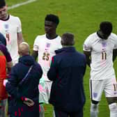 England manager Gareth Southgate stands dejected alongside Bukayo Saka and Jack Grealish following the UEFA Euro 2020 Final at Wembley Stadium, London picture: Mike Egerton
