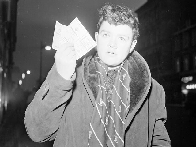 Wearing his official Hearts Supporter scarf, Alex Spence shows off his sought-after two tickets for the Hearts v Hibs Edinburgh Derby at Tynecastle on New Year's Day 1965.