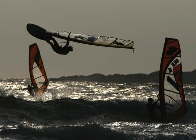 The Atlantic winds powering these windsurfers on Tiree get even stronger further out to sea (Picture: Andrew Milligan/PA)
