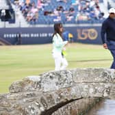 Tiger Woods walks acros the Swilcan Bridge along with his partner, Erica Herman, during a practice round prior to The 150th Open at St Andrews in July. Picture: Warren Little/Getty Images.