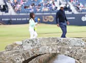 Tiger Woods walks acros the Swilcan Bridge along with his partner, Erica Herman, during a practice round prior to The 150th Open at St Andrews in July. Picture: Warren Little/Getty Images.