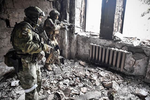 Russian soldiers in what was once a theatre in Mariupol (Picture: Alexander Nemenov/AFP via Getty Images)