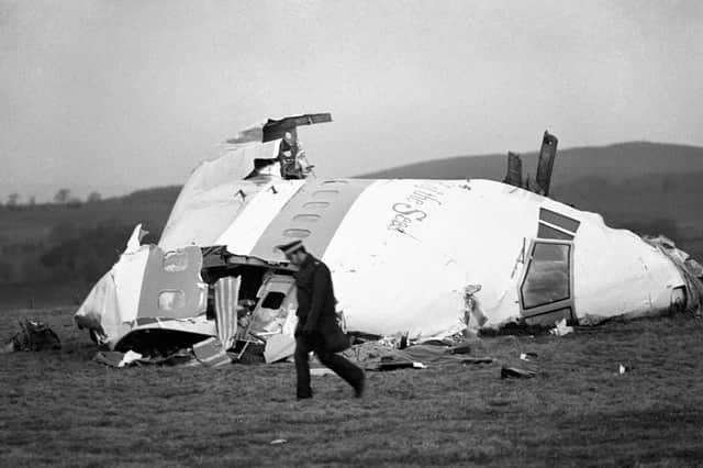 A police officer walks near the wrecked nose section of the Pan-Am flight 103 in Lockerbie in December 1988 (Picture: PA)