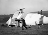A police officer walks near the wrecked nose section of the Pan-Am flight 103 in Lockerbie in December 1988 (Picture: PA)