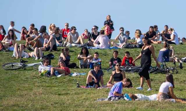 People enjoying the Autumn sunshine on Primrose Hill, London. The "rule of six" restrictions come into force on Monday.