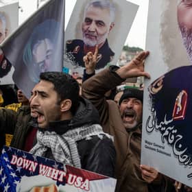 Protesters hold posters of Iranian Revolutionary Guard Major General Qassem Soleimani outside the US Consulate in Istanbul after he was killed by a drone strike (Picture: Chris McGrath/Getty Images)