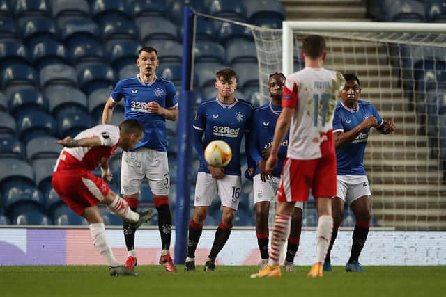 The Rangers wall attempt to block a free kick taken by Nicolae Stanciu of Slavia Praha who scores their side's second goal during the UEFA Europa League Round of 16 Second Leg match between Rangers and Slavia Praha at Ibrox Stadium on March 18. (Photo by Ian MacNicol/Getty Images)