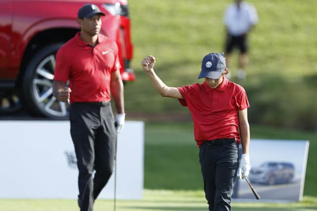 Charlie Woods reacts on the 17th tee as father Tiger Woods watches during the second round of the PNC Championship golf tournament last week.