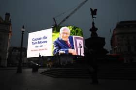 A tribute to Captain Sir Tom Moore is broadcast on the Piccadilly Circus lights in central London. The 100-year-old charity fundraiser died on Tuesday after testing positive for Covid-19. Photo credit : Victoria Jones/PA Wire