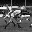 Hibs goalkeeper Andy Goram takes possession as Hearts winger John Colquhoun looks on during a goalless Edinburgh derby in March 1988