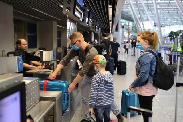 Tourists wait to check in for the first package tour flight to Mallorca.(Photo: Andreas Rentz/Getty Images)