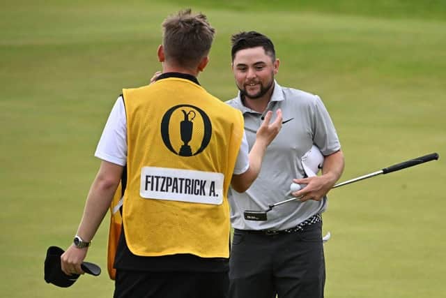 Alex Fitzpatrick celebrates with his caddie Connor Winstanley after holing a putt on the 18th green at Royal Liverpool. Picture: Paul Ellis/AFP via Getty Images.