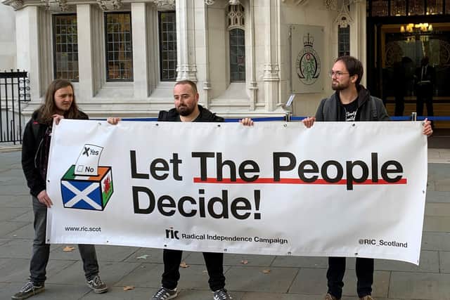 Demonstrators outside the Supreme Court in central London ahead of justices hearing arguments in a case which could allow the Scottish Parliament to legislate for a second referendum on independence. Picture date: Tuesday October 11, 2022.