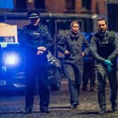 Martin Compston as Steve Arnott leads the charge at the scene of the Fleming-Pilkington shootout