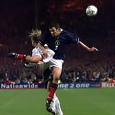 Davidson beats David Beckham to a a high ball playing for Scotland against England in 1999 - and according to his managed "eliminated" Becks in the Euros playoff.