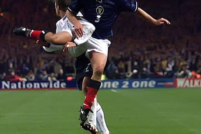 Davidson beats David Beckham to a a high ball playing for Scotland against England in 1999 - and according to his managed "eliminated" Becks in the Euros playoff.