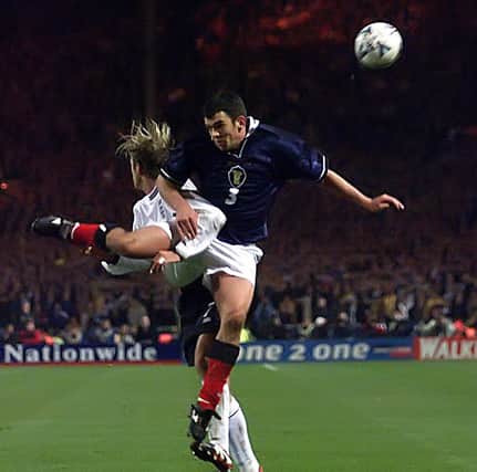 Davidson beats David Beckham to a a high ball playing for Scotland against England in 1999 - and according to his managed "eliminated" Becks in the Euros playoff.