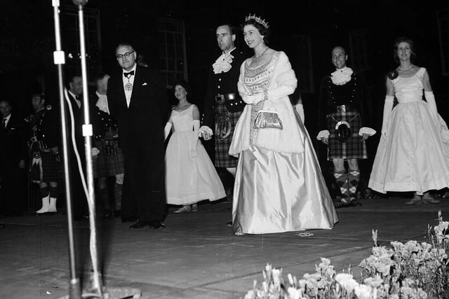 Queen Elizabeth and Prince Philip Duke of Edinburgh at the 'Sunset ceremony' at the Palace of Holyroodhouse during their tour of Scotland in July 1962.