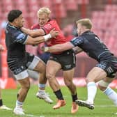 JC Pretorius, a try-scorer for the Emirates Lions, tries to squeeze past and Glasgow Warriors' Sione Tuipulotu and Kyle Steyn.  (Photo by Steve Haag Sports/INPHO/Shutterstock)
