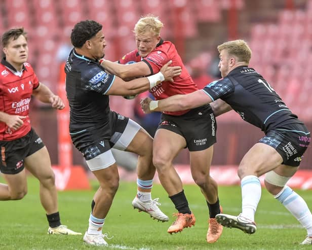 JC Pretorius, a try-scorer for the Emirates Lions, tries to squeeze past and Glasgow Warriors' Sione Tuipulotu and Kyle Steyn.  (Photo by Steve Haag Sports/INPHO/Shutterstock)
