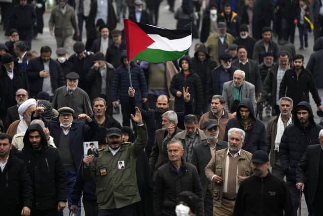 A man holds up a Palestinian flag during a demonstration in which worshippers show their support of Palestinians and condemning the U.S. and British militaries strike against Iranian-backed Houthis in Yemen, after Friday prayer in Tehran, Iran. Picture: AP Photo/Vahid Salemi