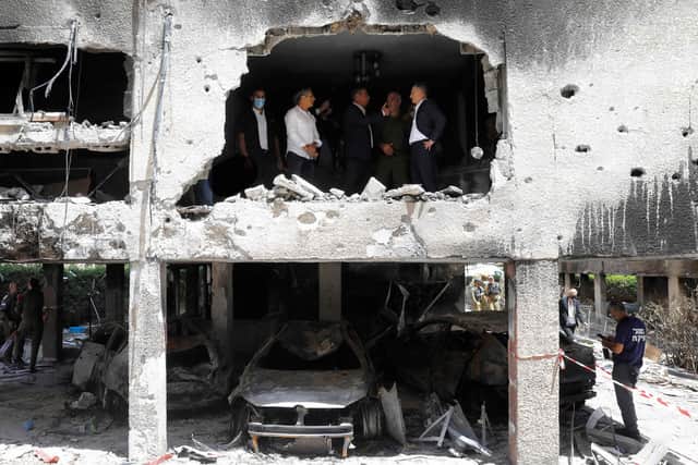 German Foreign Minister Heiko Maas (right) listens to his Israeli counterpart Gabi Ashkenazi in a building in the Israeli city of Petah Tikva that was hit by a rocket fired by Palestinian militants (Picture: Gil Cohen-Magen/AFP via Getty Images)
