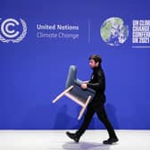 Staff remove chairs and dismantle one of the stages at COP26.
