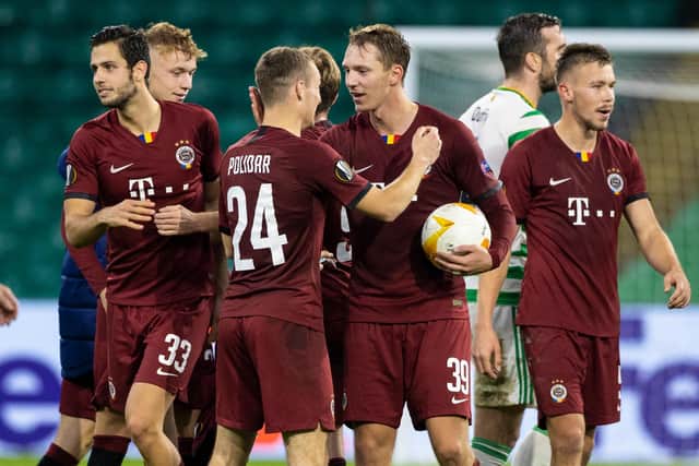 Lukas Julis with the matchball as he's congratulated by his team-mates following his hat-trick against Celtic. Picture: SNS