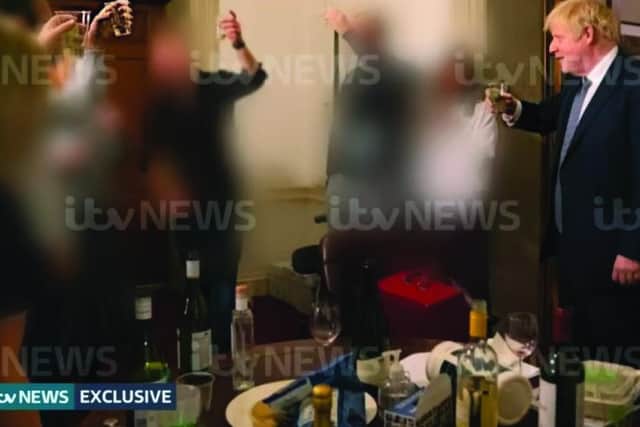 The pictures showed the Prime Minister with a glass in his hand behind a table filled with alcohol and food
