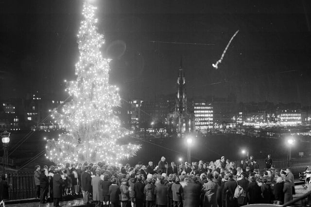 Crowds watch the lights of the Mound Christmas being turned on, with a view of Edinburgh's Princes Street, in 1966.