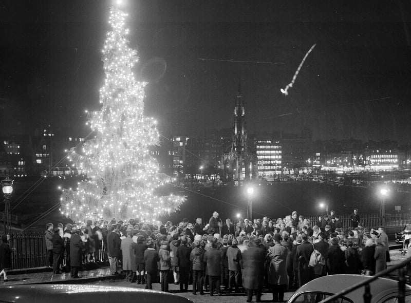 Crowds watch the lights of the Mound Christmas being turned on, with a view of Edinburgh's Princes Street, in 1966.