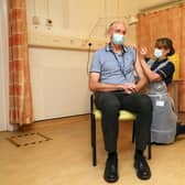 Professor Andrew Pollard, director of the Oxford Vaccine Group, receives the Oxford University/AstraZeneca Covid-19 vaccine from nurse Sam Foster at the Churchill Hospital in Oxford (Picture: Steve Parsons/PA)