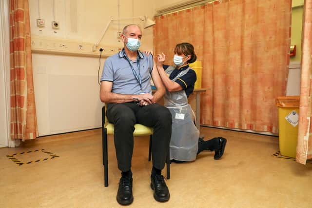Professor Andrew Pollard, director of the Oxford Vaccine Group, receives the Oxford University/AstraZeneca Covid-19 vaccine from nurse Sam Foster at the Churchill Hospital in Oxford (Picture: Steve Parsons/PA)