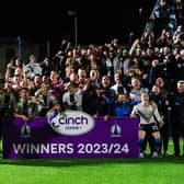 Falkirk players and coaching staff celebrate winning the cinch League 1 title.