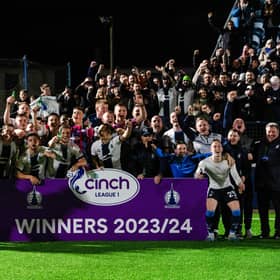 Falkirk players and coaching staff celebrate winning the cinch League 1 title.