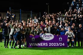 Falkirk players and coaching staff celebrate winning the cinch League 1 title.