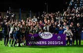 Falkirk players and coaching staff celebrate winning the cinch League 1 title.