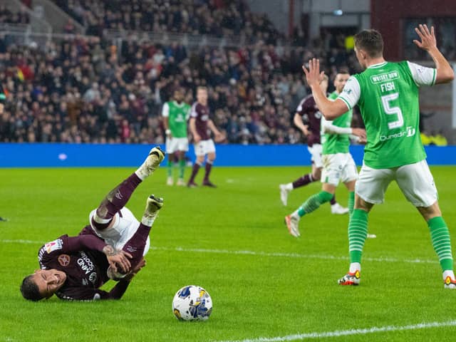 Hearts' Kenneth Vargas goes down in the box after a challenge from Hibs' Will Fish.