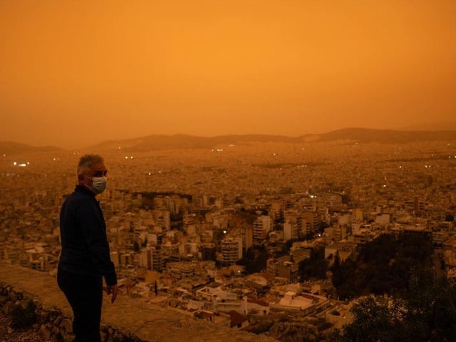 People with respiratory problems have been told to stay indoors or wear a mask, as this man is doing.