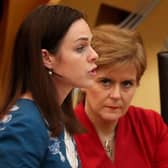 Finance Secretary Kate Forbes, seen with watched by Nicola Sturgeon, has offered councils money if they will agree to freeze council tax (Picture: Andrew Milligan/PA)