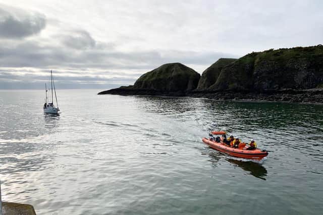 The crew of the Jamie Hunter lifeboat escort the sailing vessel into Stonehaven harbour (Photo: RNLI).