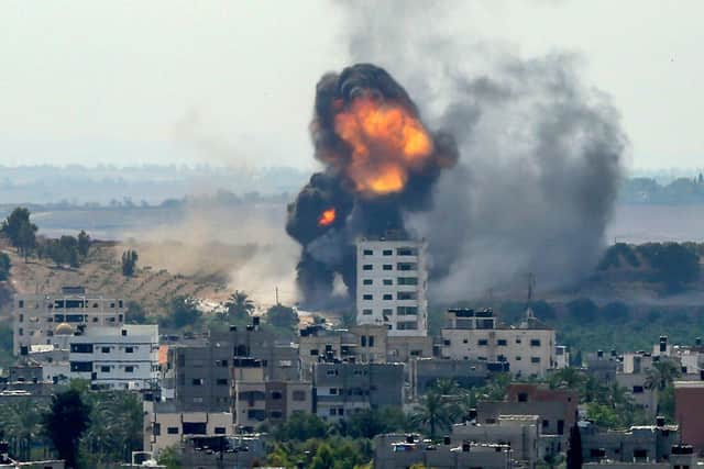 A ball of fire erupts from a building in Gaza City's Rimal residential district (Picture: Bashar Taleb/AFP via Getty Images)