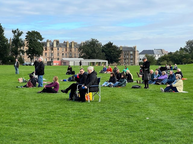 People bring chairs and food in preparation.