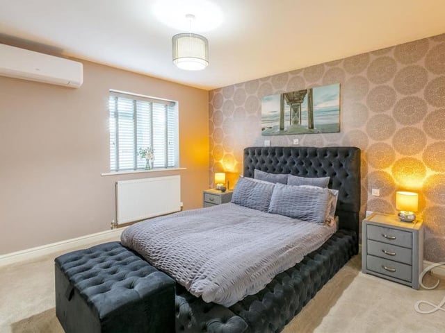 And so to the two bedrooms, the first of which is a lovely, warm space. It boasts fitted wardrobes, a storage cupboard, a carpeted floor and even air conditioning, which must be bliss during those hot summer nights in bed.