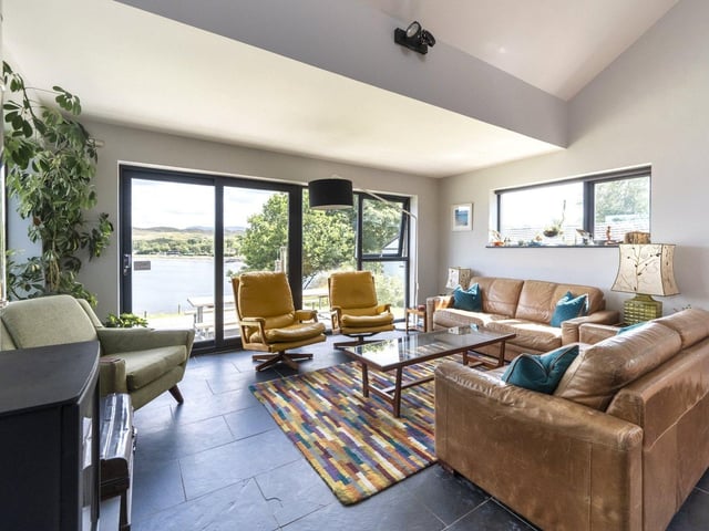The living room has doors out to the garden, and makes the most of the views.