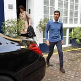 Rishi Sunak outside his home in London on Saturday morning.  He is believed to have become the first Conservative leadership candidate to secure the backing of 100 MPs, shoring up sufficient support to be on the ballot for Monday's vote. Beresford Hodge/PA Wire