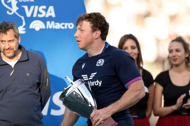 Scotland's Hamish Watson receives the player of the match trophy. (Photo by Pablo Gasparini / AFP)