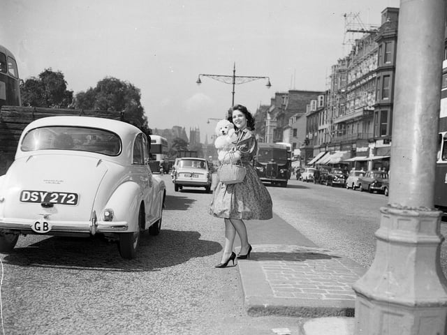 Miss Souness of Sighthill Terrace crosses Princes Street with her pet poodle during the 1960 Edinburgh heatwave.
