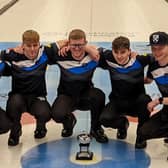 James Craik (far left) and his team with the World Junior Curling Championship trophy.